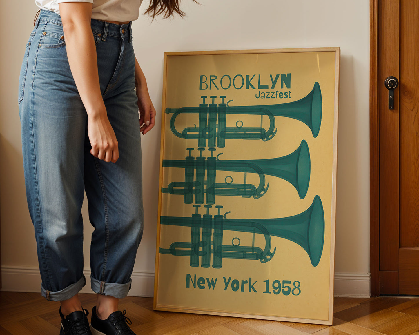 Person standing next to a framed poster with musical instruments and text on a wall.