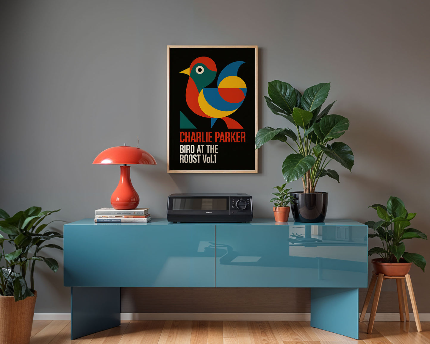 Modern interior with a blue console table, red lamp, and framed poster on a gray wall.