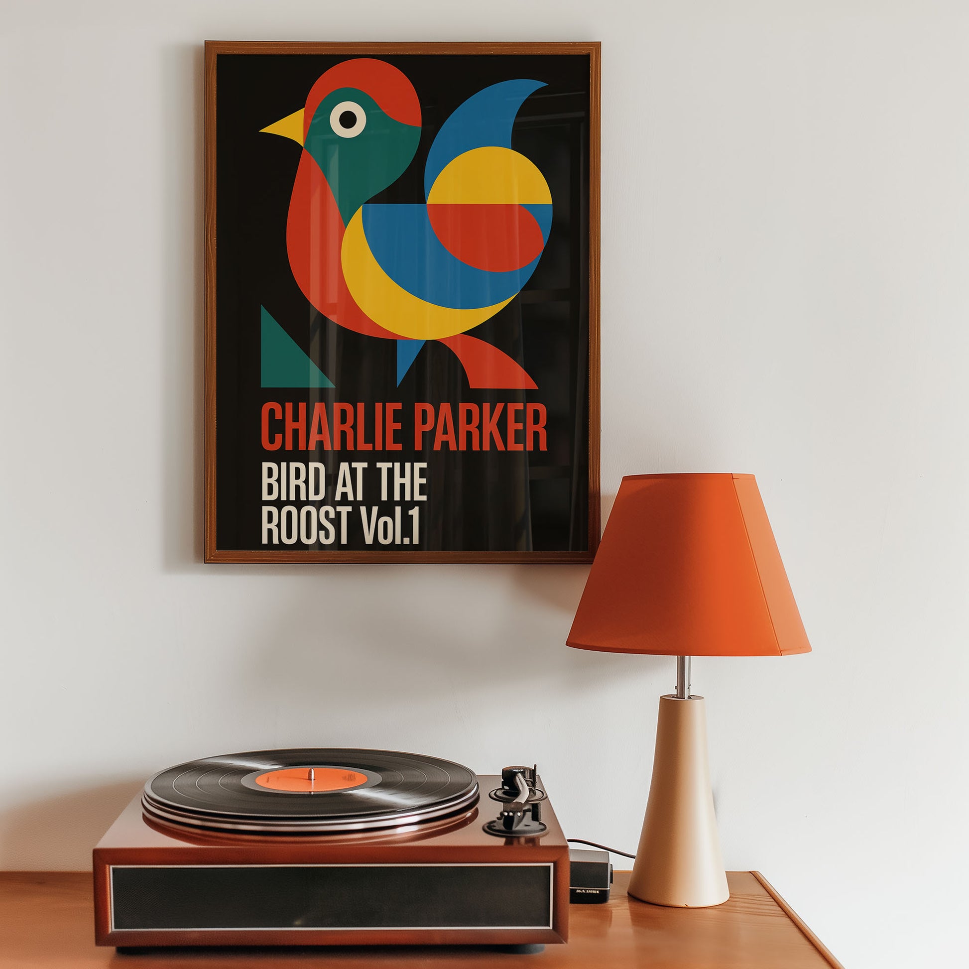 Framed poster of Charlie Parker's 'Bird at the Roost Vol. 1' above a record player with an orange lamp.