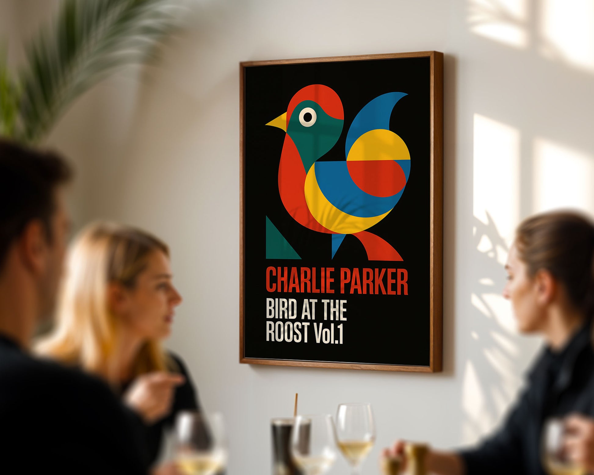 Framed poster of a colorful bird with 'Charlie Parker' text in a room with people socializing.