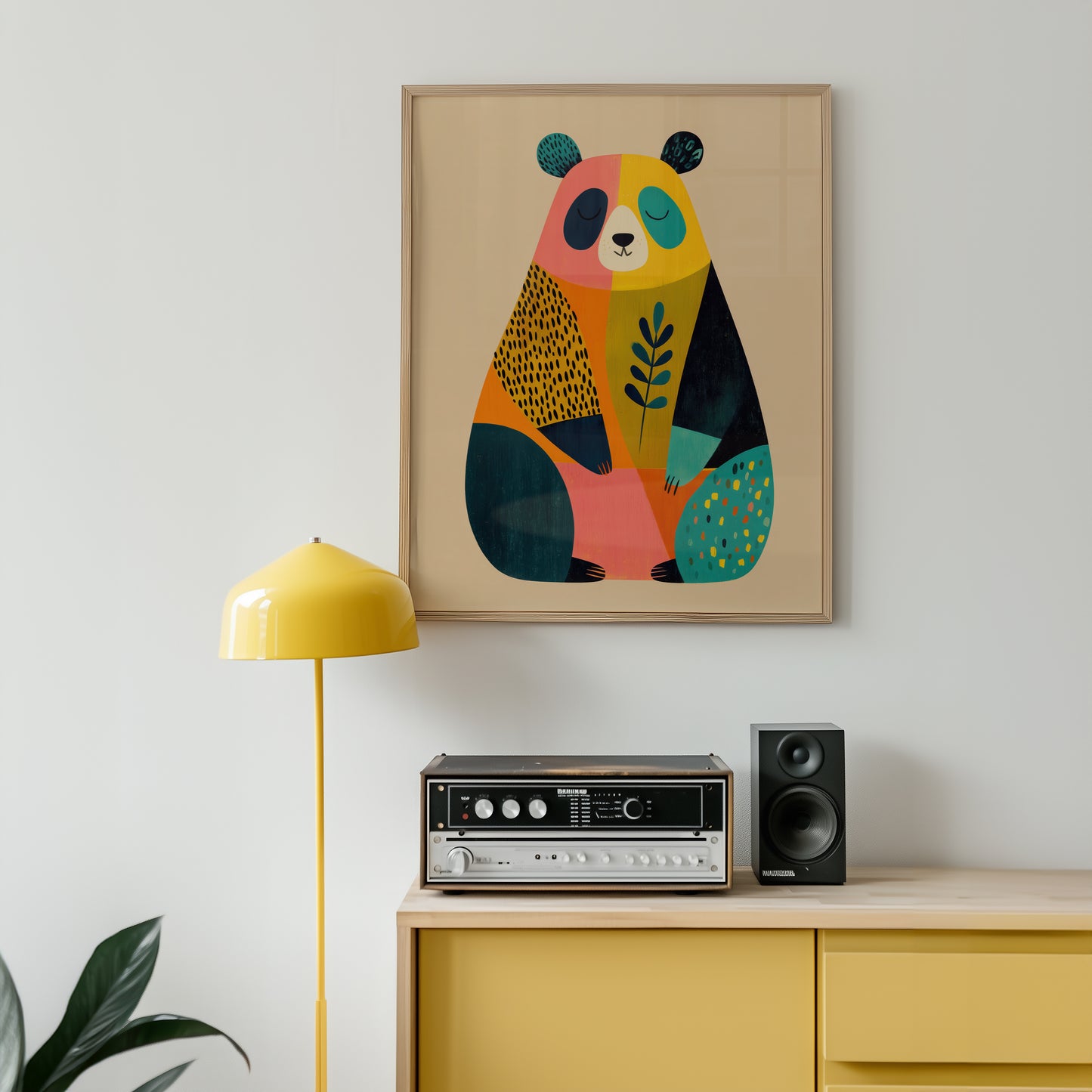 Colorful abstract bear artwork on a wall above a yellow cabinet with stereo equipment.
