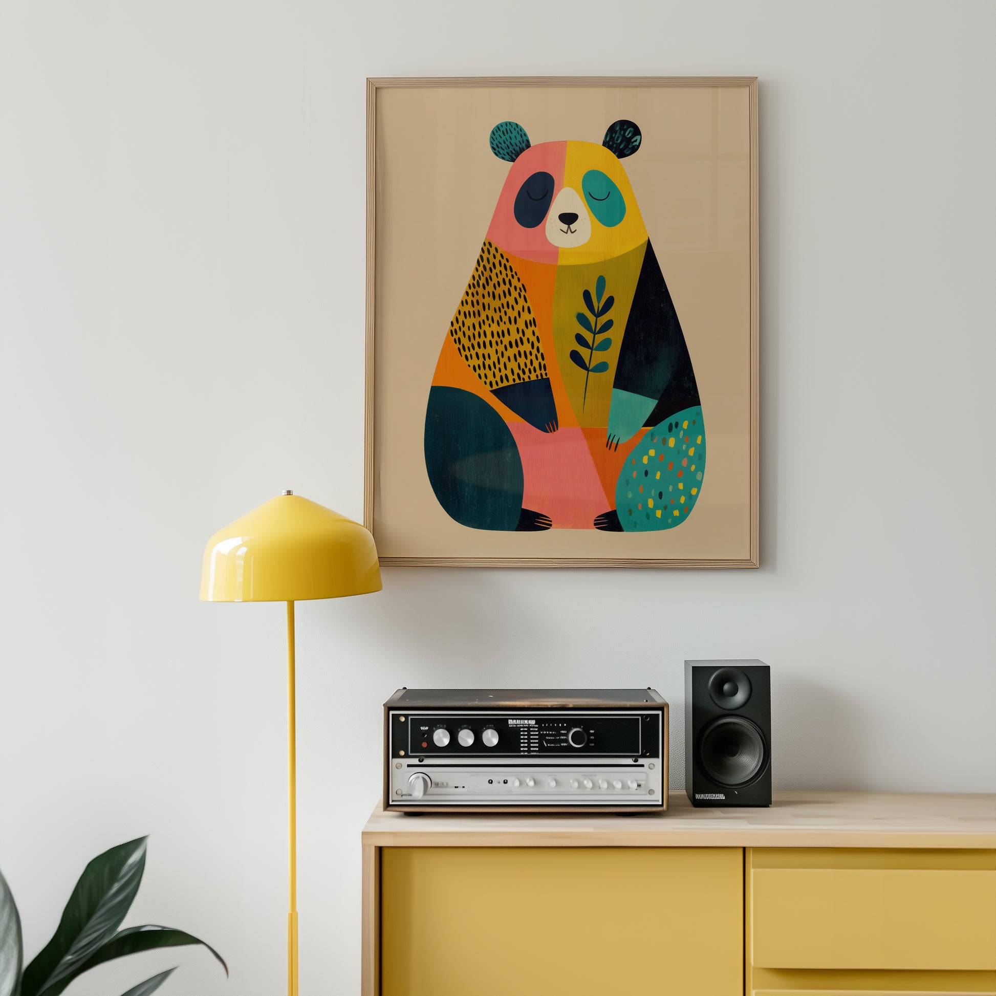 Colorful abstract bear artwork on a wall above a yellow cabinet with stereo equipment.
