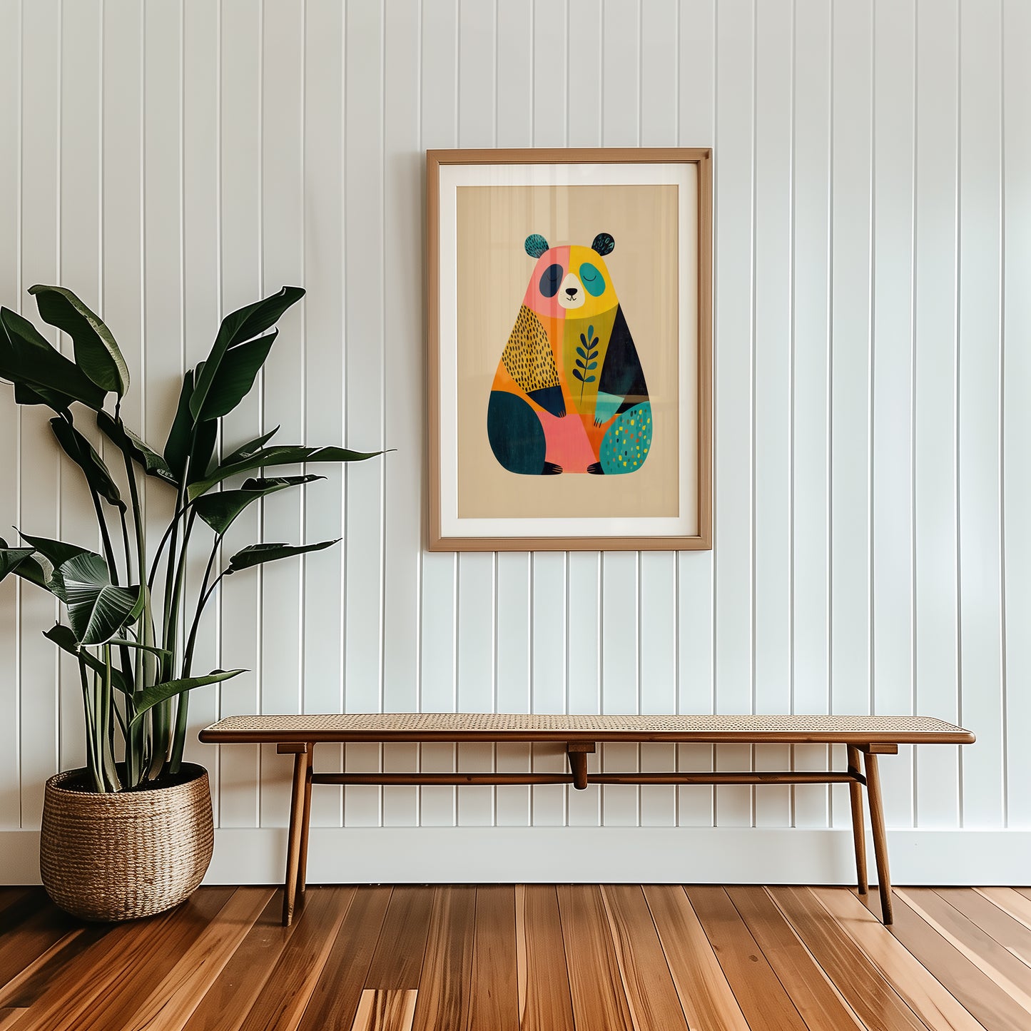 Colorful panda illustration in a wooden frame on a white paneled wall with a wooden bench and plant.