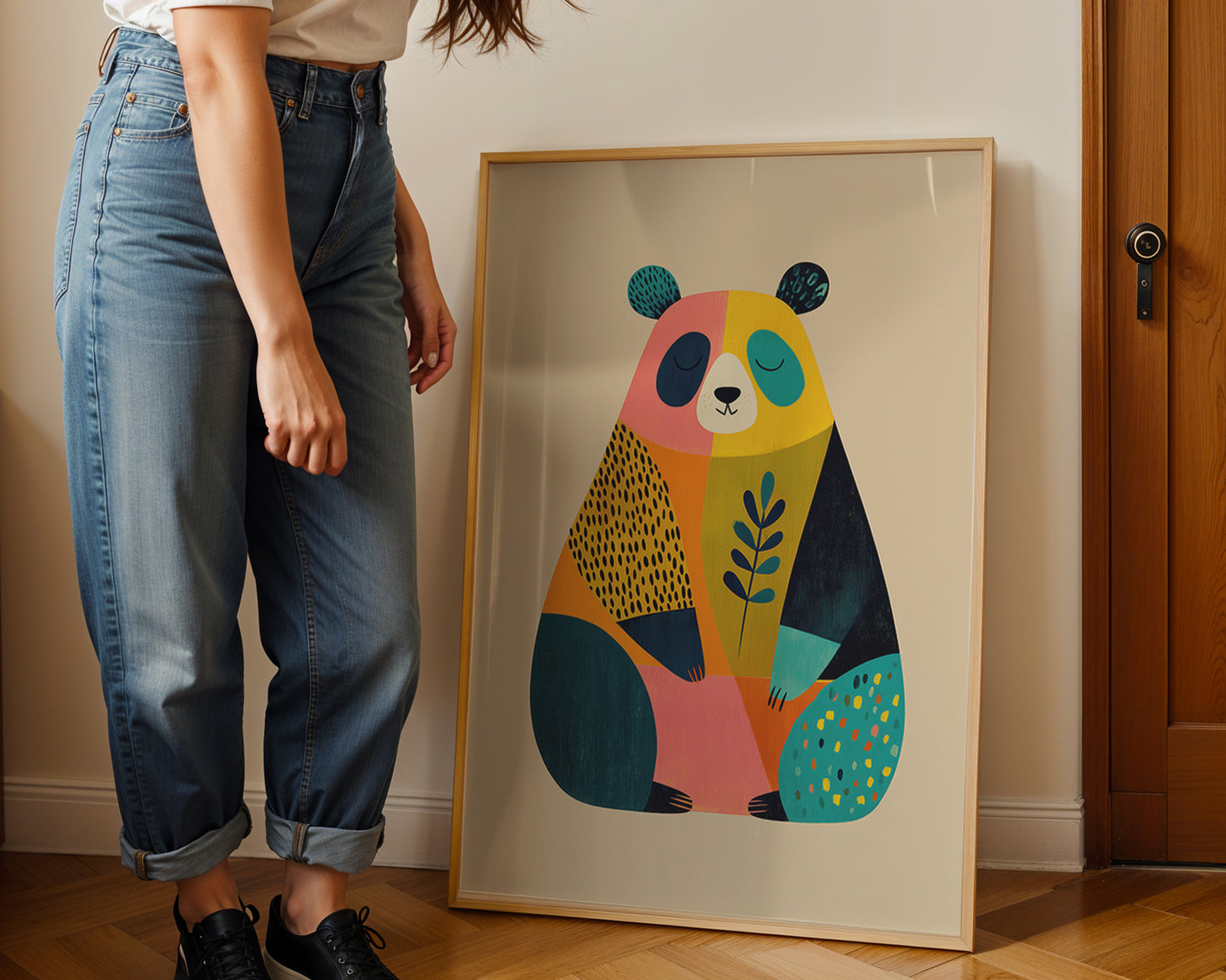 Person standing next to a colorful abstract bear painting on a wall.