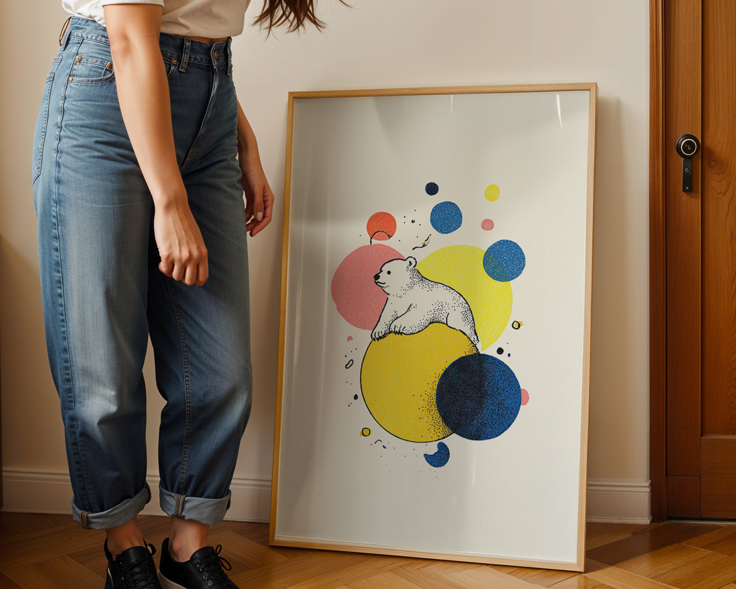 Young woman  standing next to a framed colorful artwork of a bear on a wall.