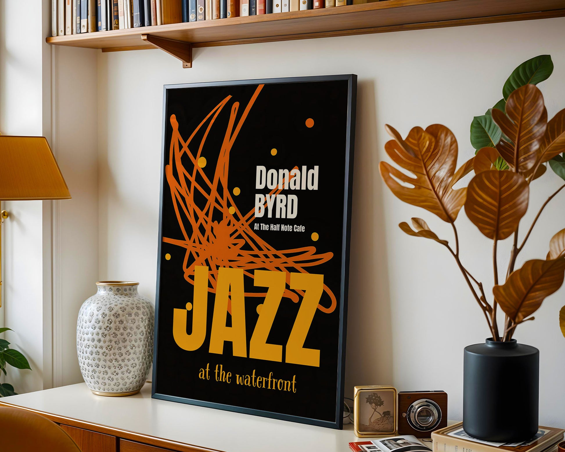 Framed poster of Donald Byrd with decorative elements on a shelf.