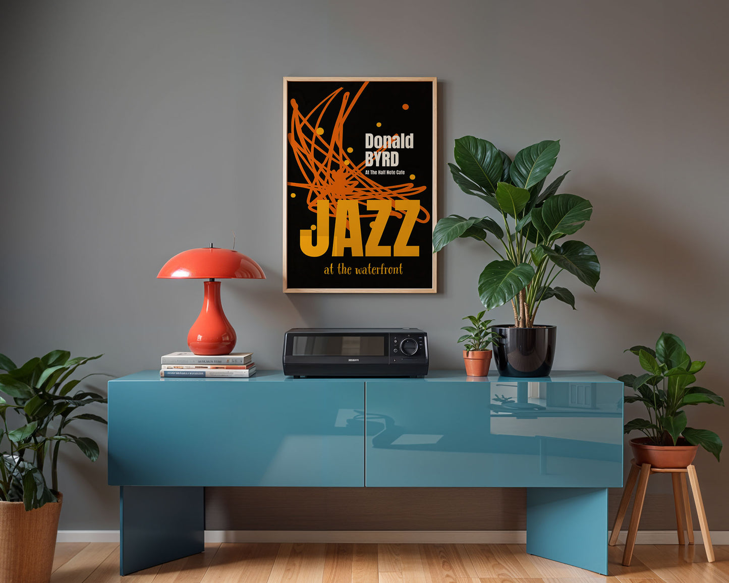 Modern interior with a blue console table, red lamp, and framed poster on a gray wall.