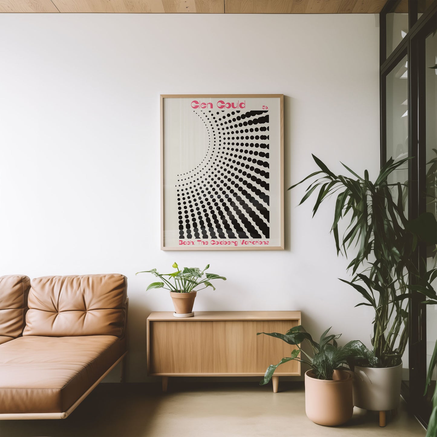 Modern living room with a beige sofa, wooden cabinet, and framed artwork on a white wall.