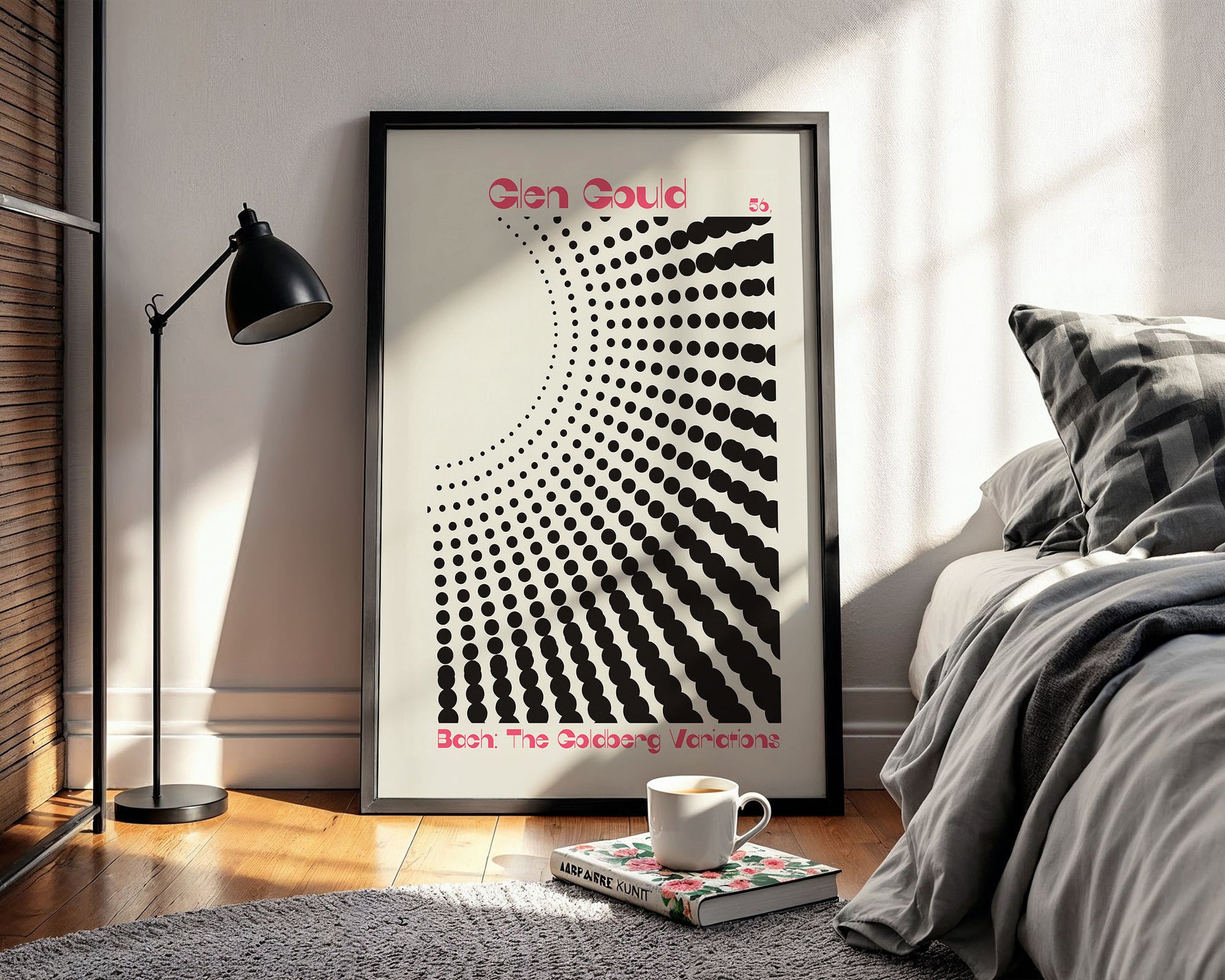 Framed abstract art print in a modern bedroom with a bed and lamp.