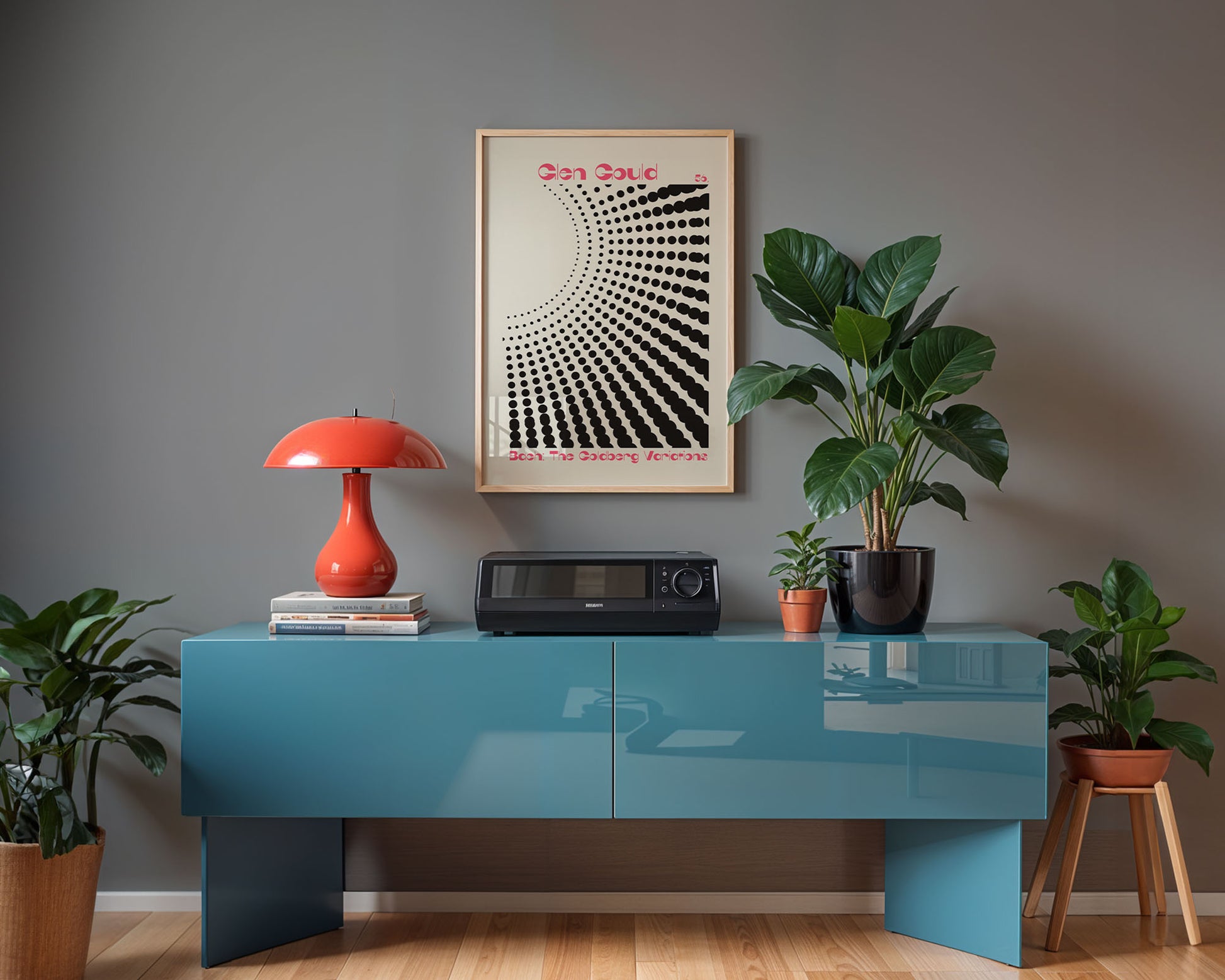 Modern interior with a blue console table, red lamp, and framed artwork on a gray wall.