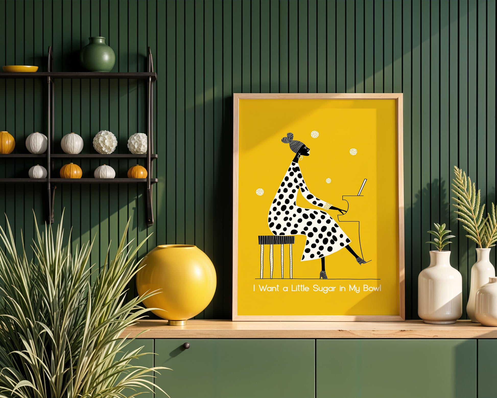 Framed Nina Simone artwork with a polka dot dress design on a wooden shelf against a green wall.