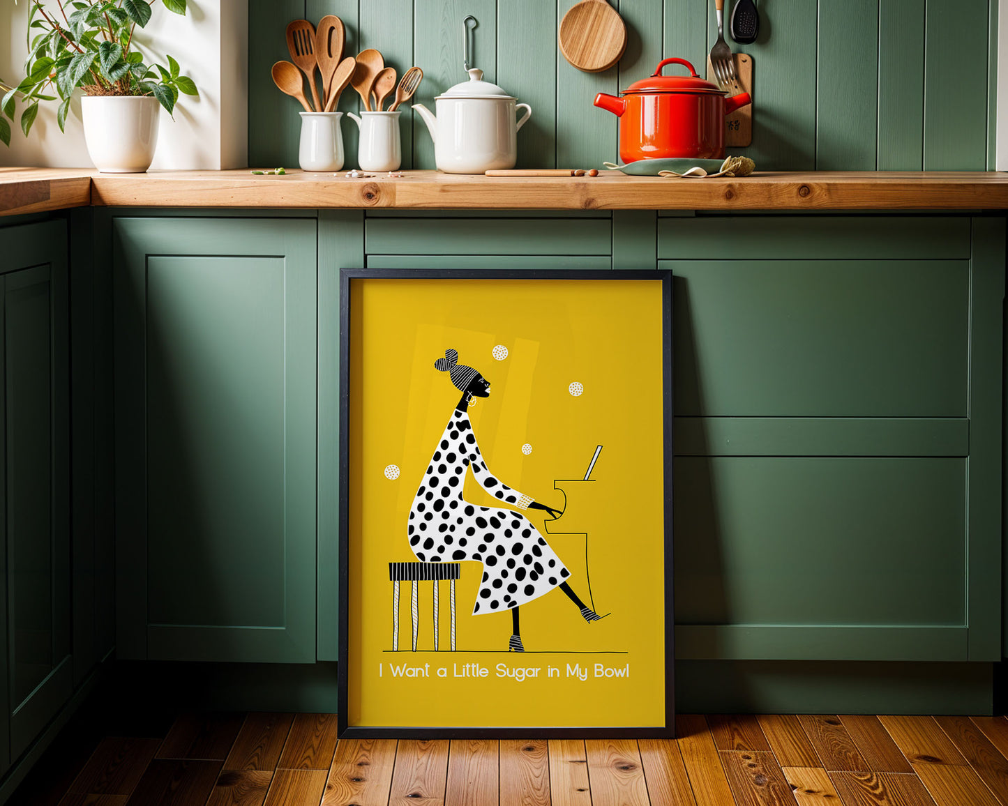 Framed artwork with a polka dot dress design on a kitchen wall.