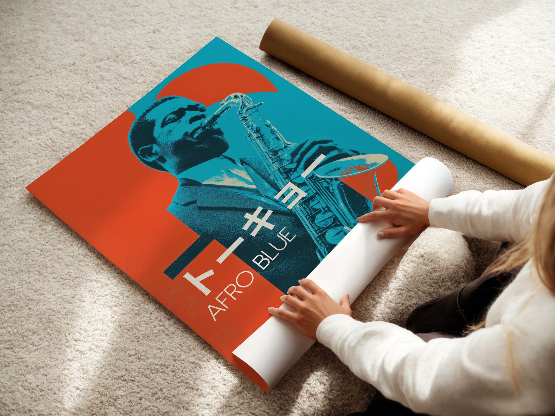 Person unrolling a poster with a stylized portrait and 'Afro Blue' text on a beige carpet.
