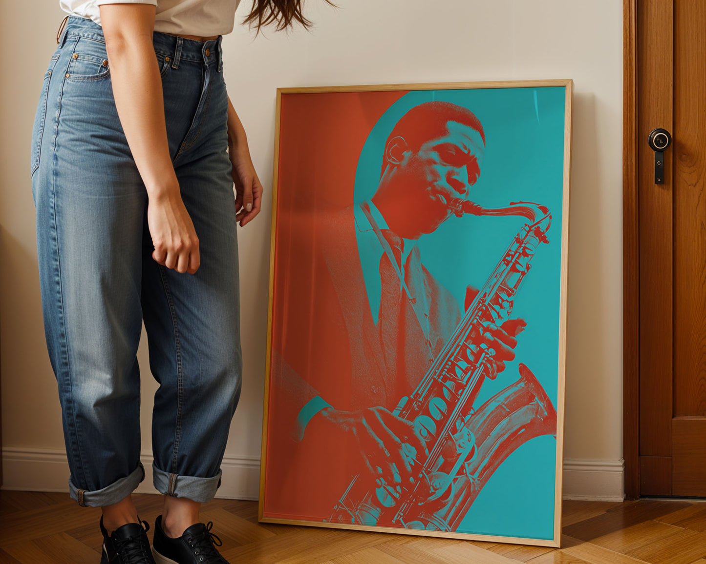 Person standing next to a framed artwork of a saxophonist on a wall.