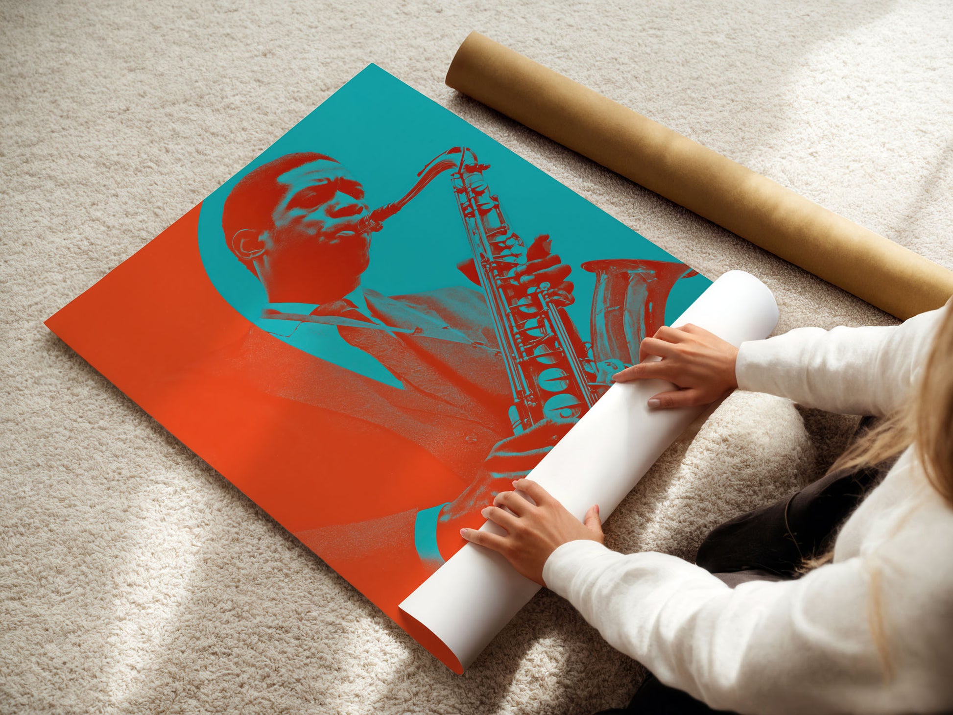 Person unrolling a poster of a saxophonist with a red and blue design on a beige carpet.