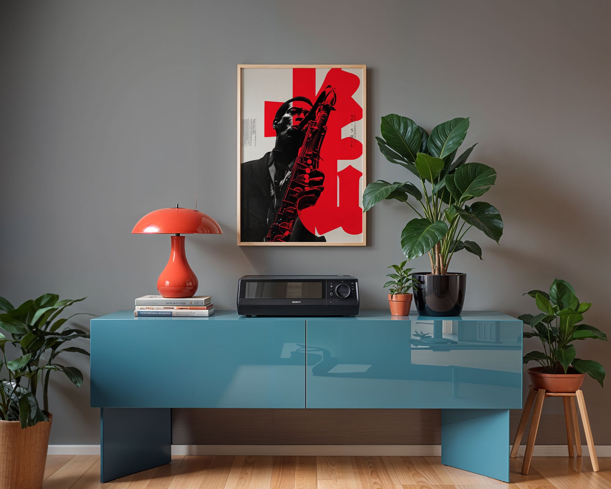 Modern interior with a blue console table, red lamp, and framed artwork on a gray wall.