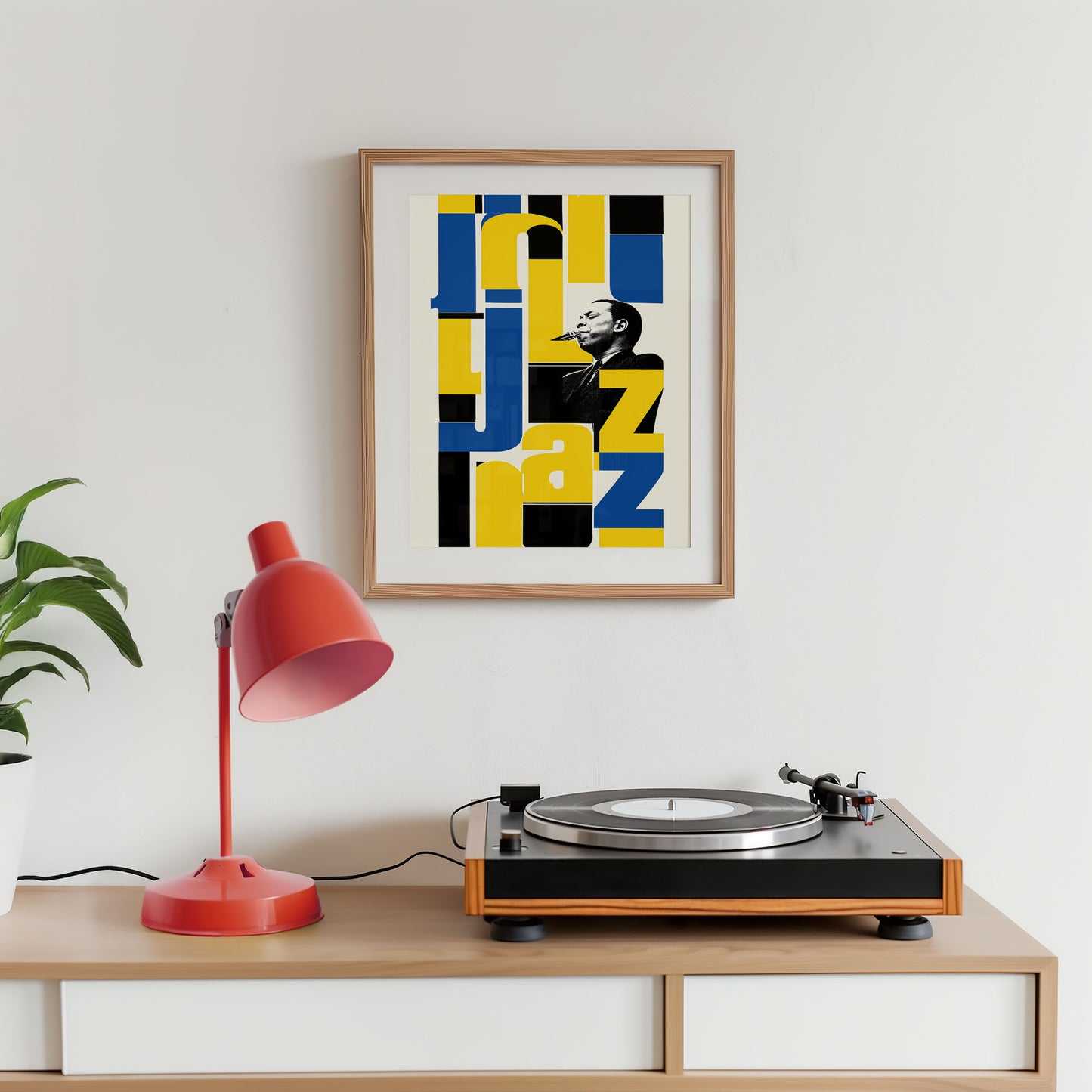 Turntable on a wooden shelf with a colorful abstract art print and red lamp against a white wall.