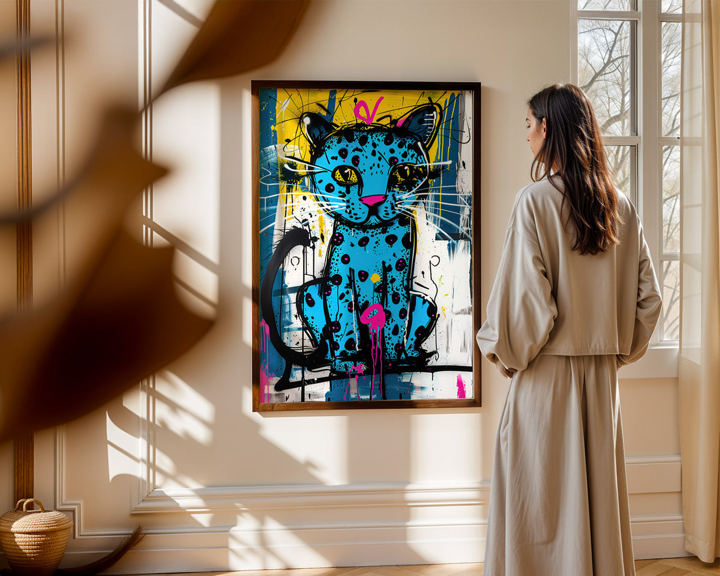 Woman looking at an eclectic gallery wall print abstract cat painting on a wall