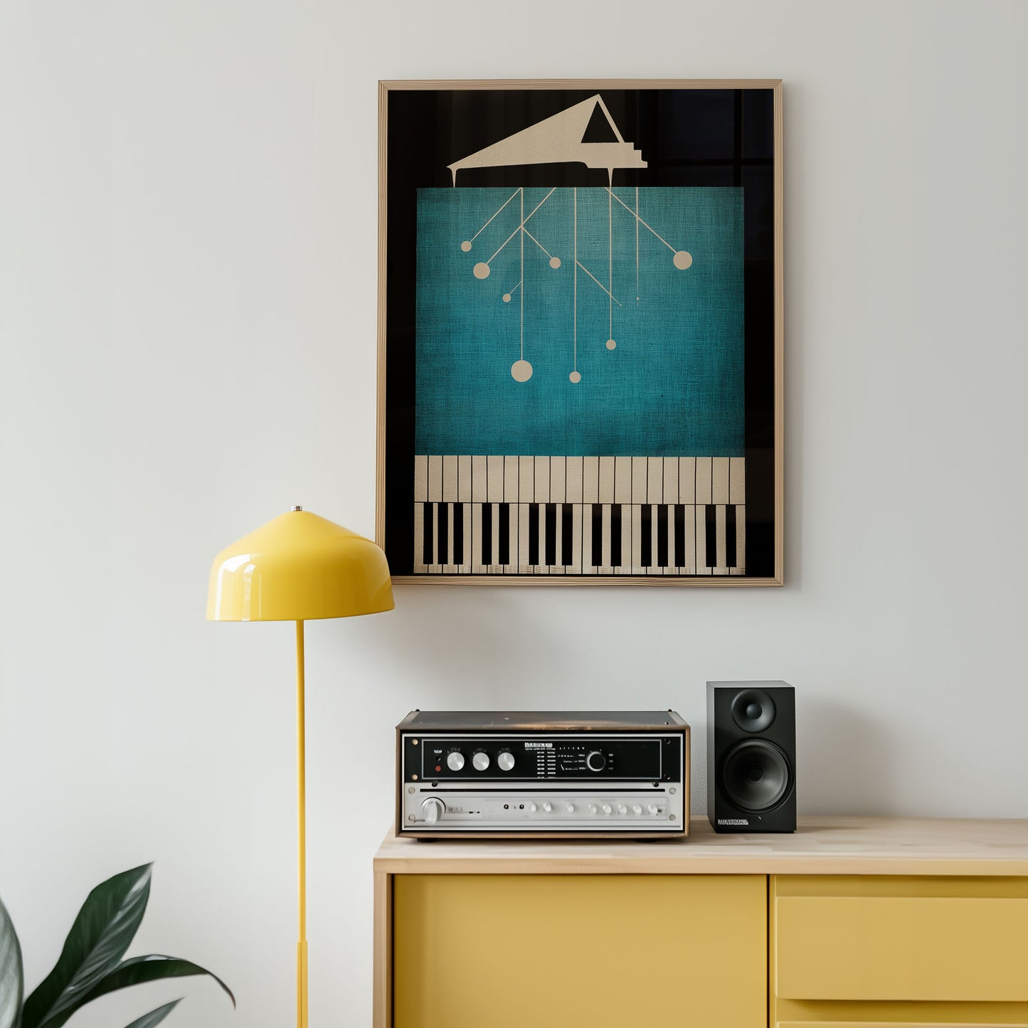 Framed abstract art piece on a wall above a yellow cabinet with stereo equipment.