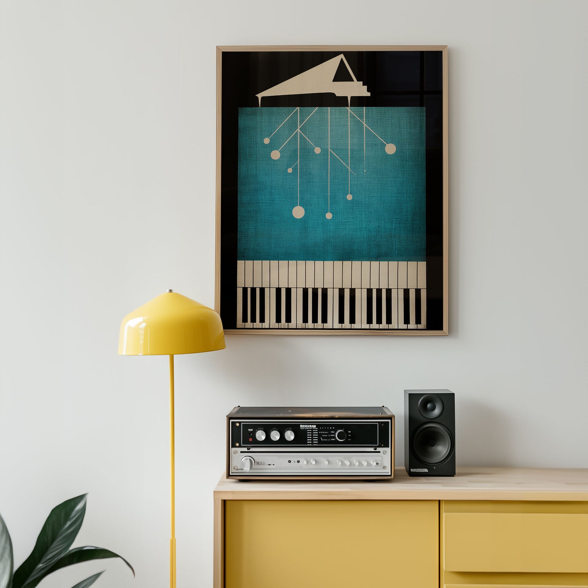 Framed abstract art piece on a wall above a yellow cabinet with stereo equipment.