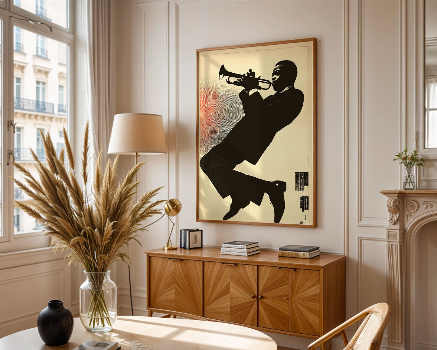 Living room with a wooden cabinet, lamp, vase, and framed artwork of a silhouette playing a trumpet.