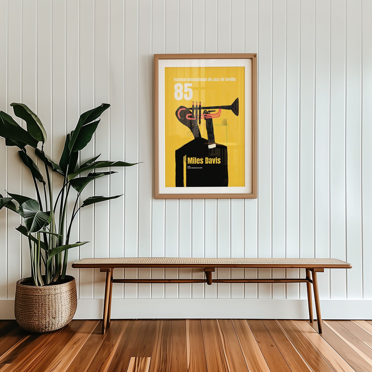 Framed artwork of Miles Davis with a plant and bench in a room.