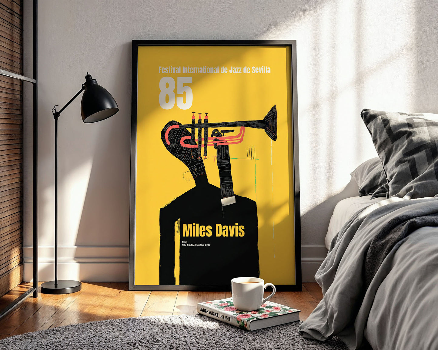 Framed Miles Davis poster in a bedroom with a bed and lamp.