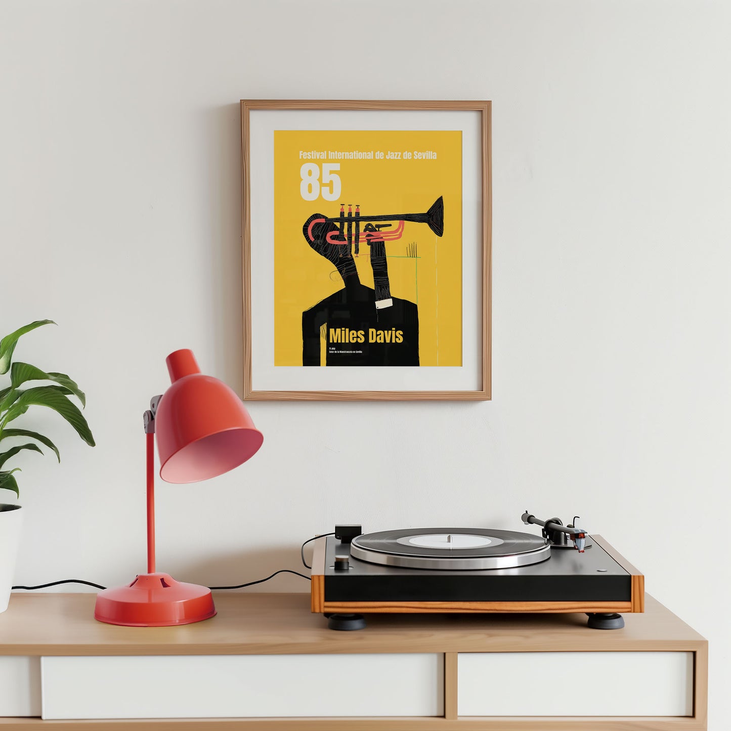 Turntable on a wooden shelf with a framed poster of Miles Davis and a red lamp.
