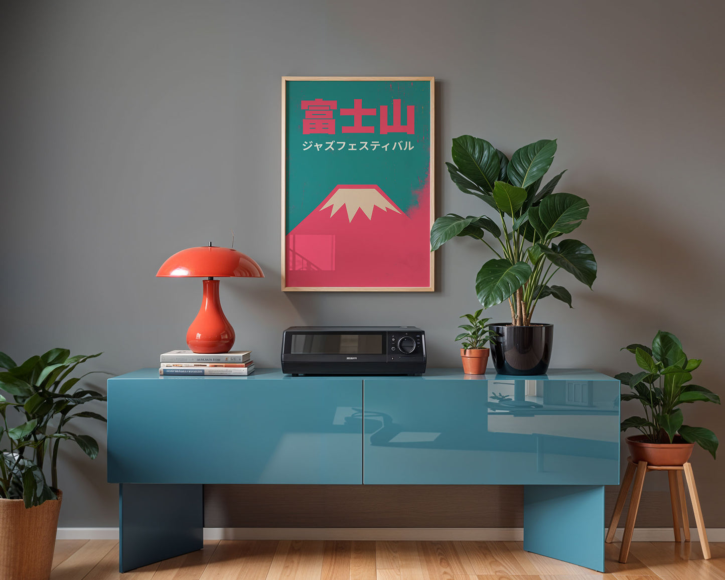 Modern interior with a blue console table, red lamp, and framed artwork on a gray wall.