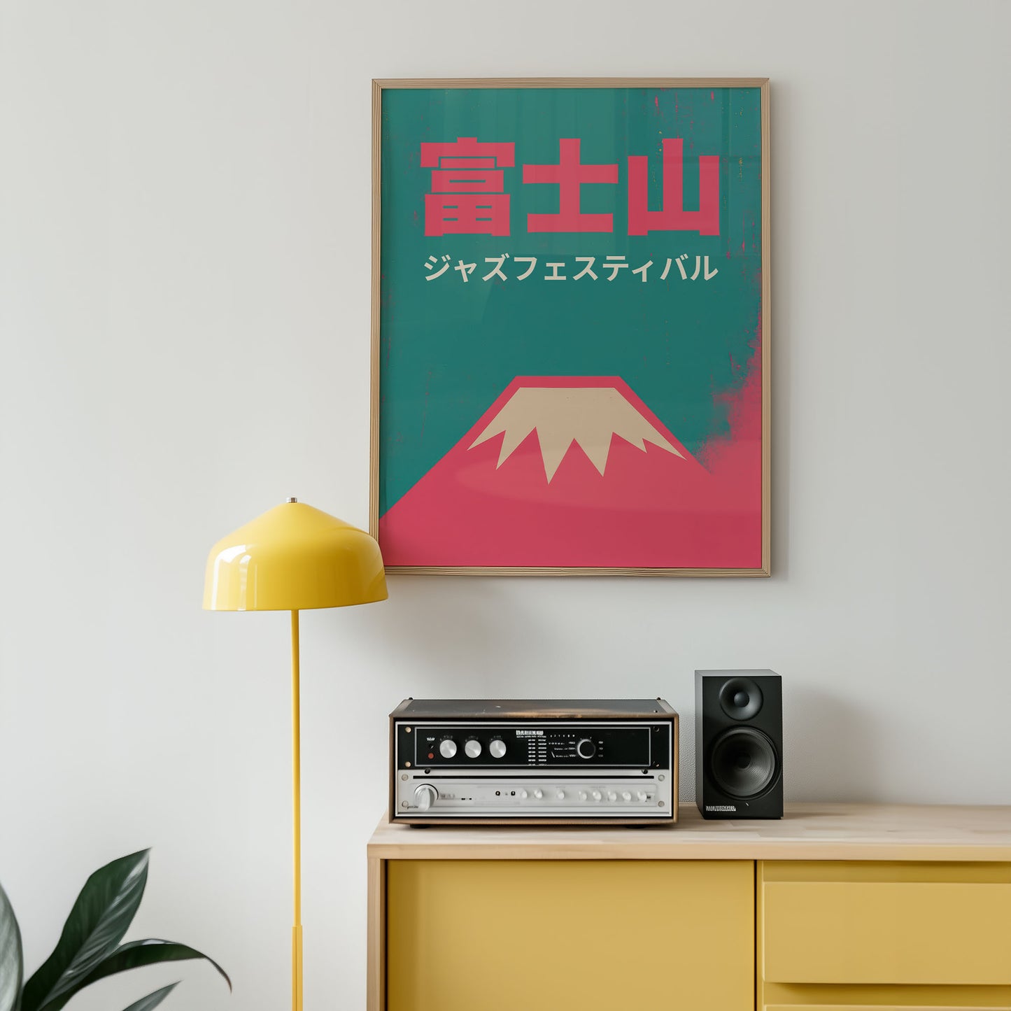 Poster of Mount Fuji with Japanese text on a wall above a yellow cabinet with audio equipment.
