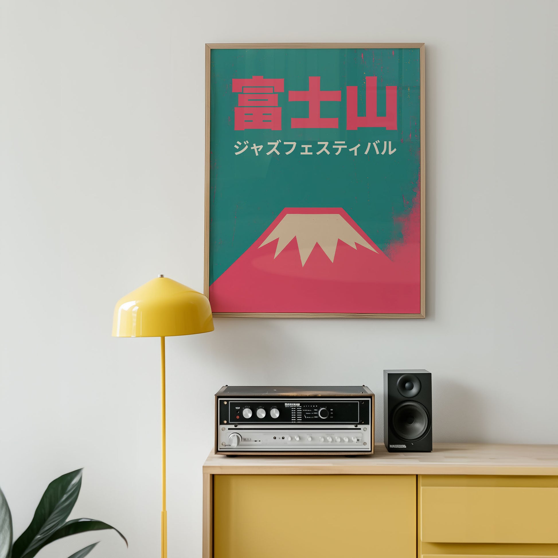 Poster of Mount Fuji with Japanese text on a wall above a yellow cabinet with audio equipment.