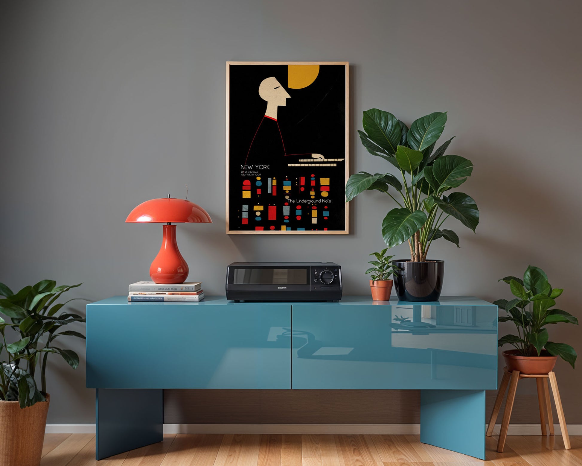 Modern interior with a blue console table, red lamp, and framed artwork on a gray wall.