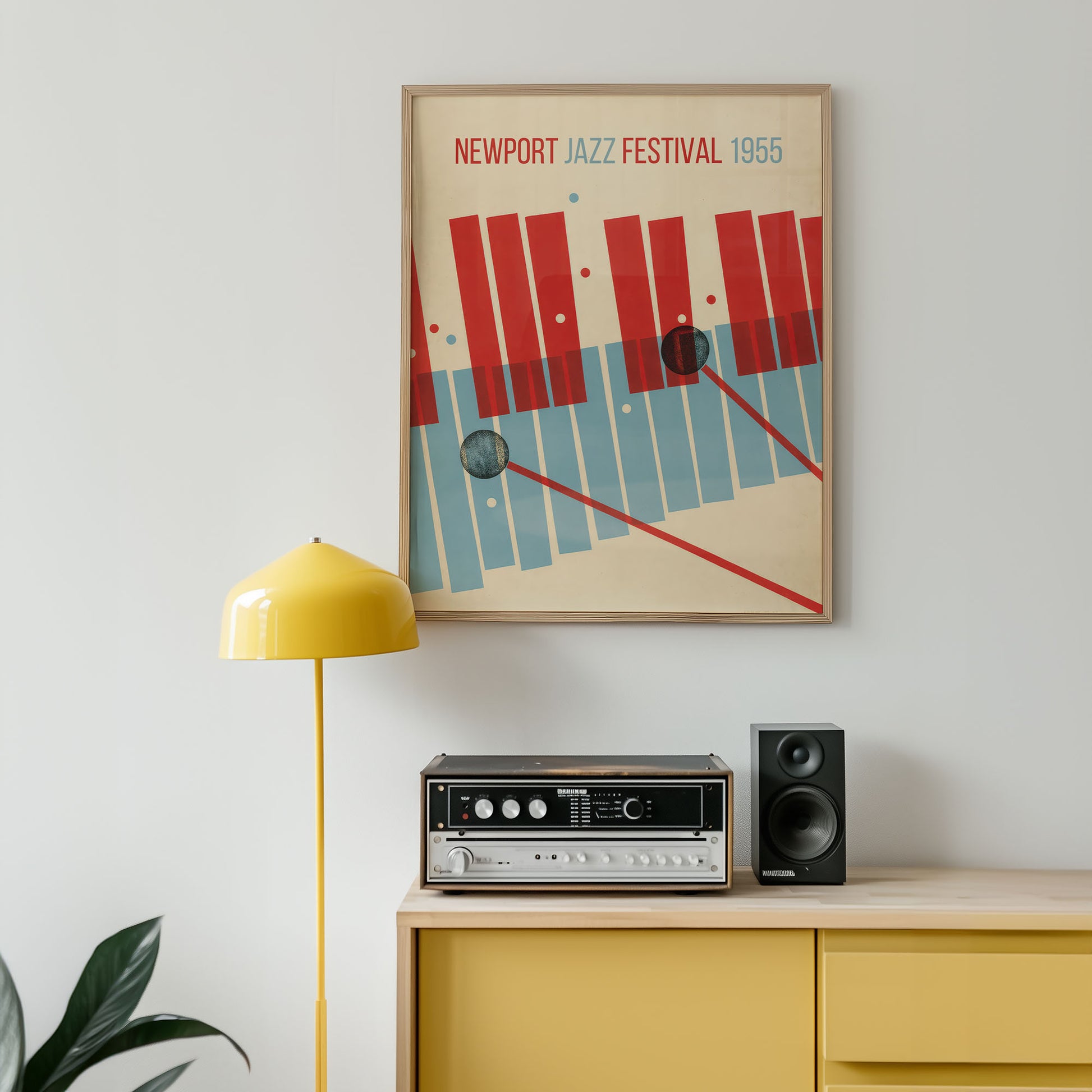 Framed poster of the Newport Jazz Festival 1955 above a wooden cabinet with audio equipment.
