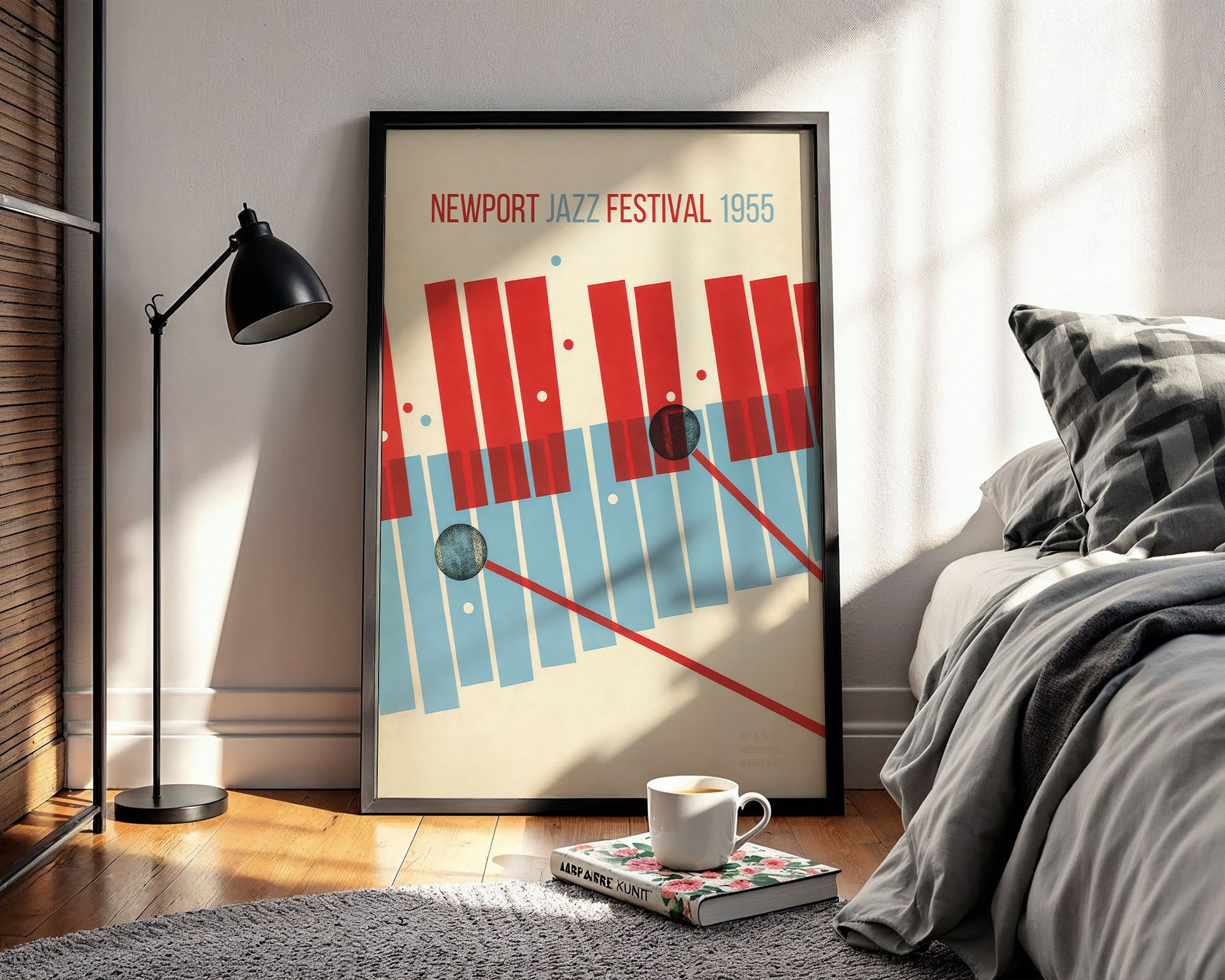 Framed poster of the Newport Jazz Festival 1955 in a bedroom setting with a lamp and bed.