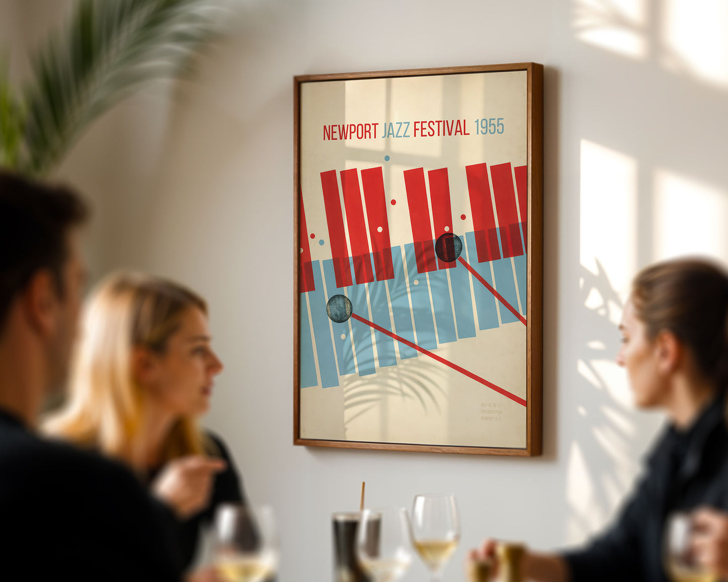 Framed poster of the Newport Jazz Festival 1965 on a wall with people in the foreground.