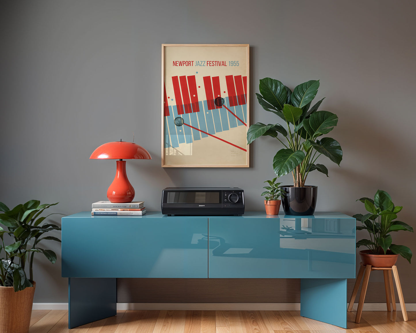 Modern interior with a blue console table, red lamp, and framed poster on a gray wall.