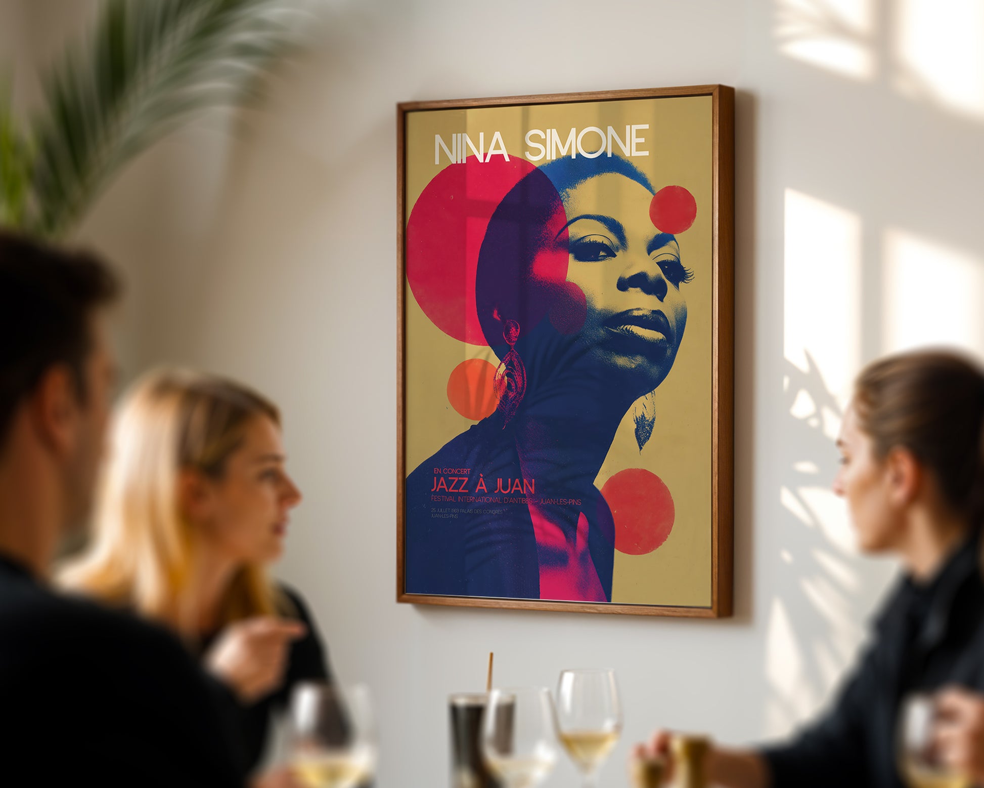 Poster of Nina Simone on a wall in a social setting with people and drinks.