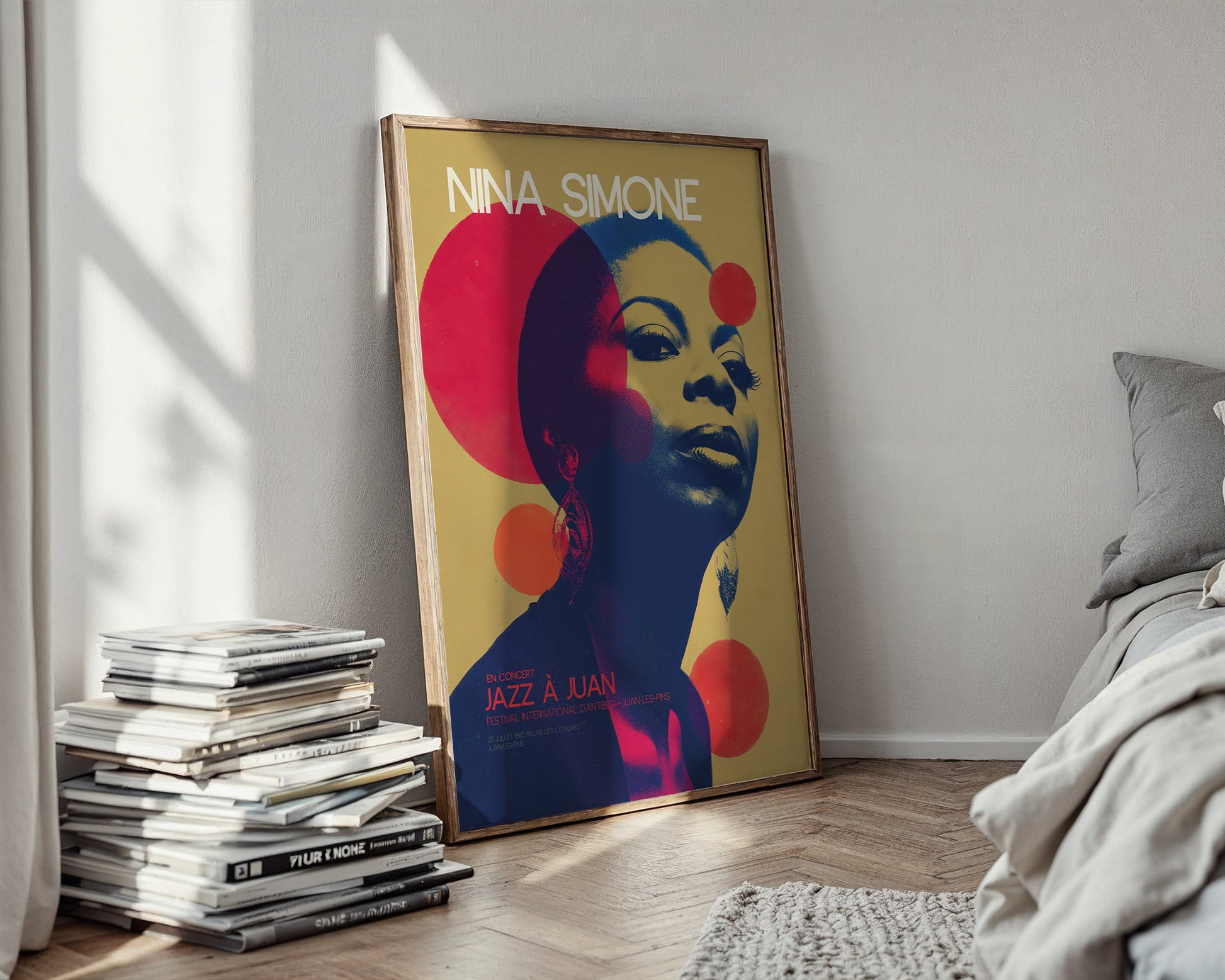 Colorful Nina Simone poster in a bedroom with books and a bed.