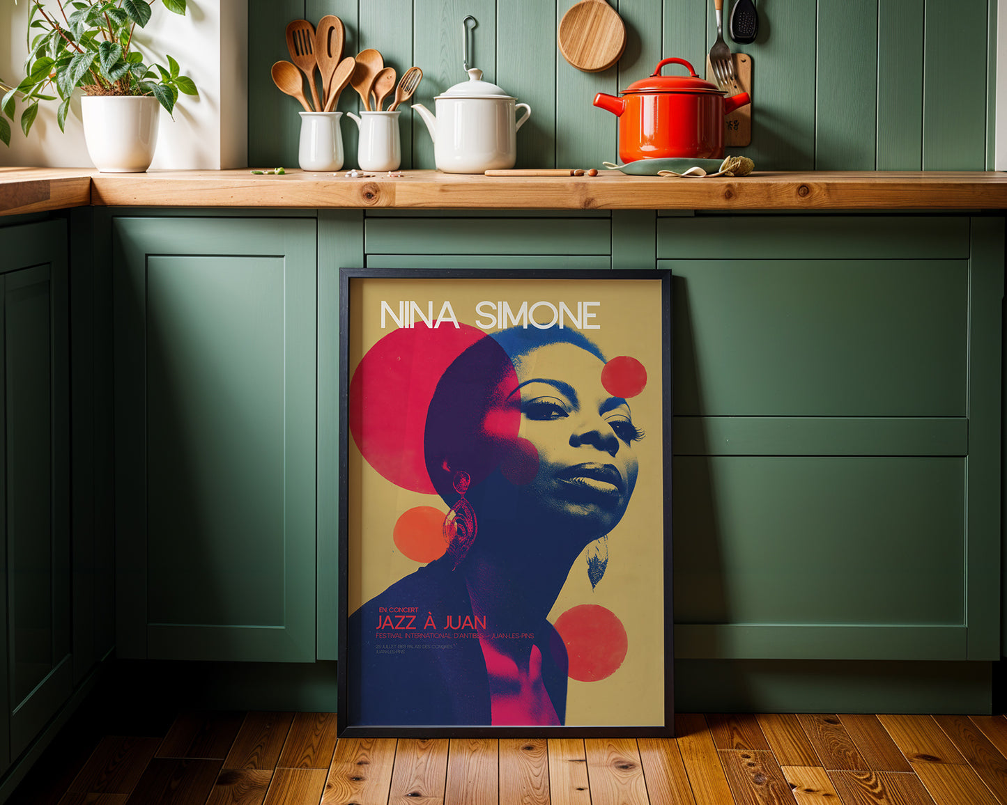Mid-century modern wall art in a kitchen with green walls and wooden countertops.