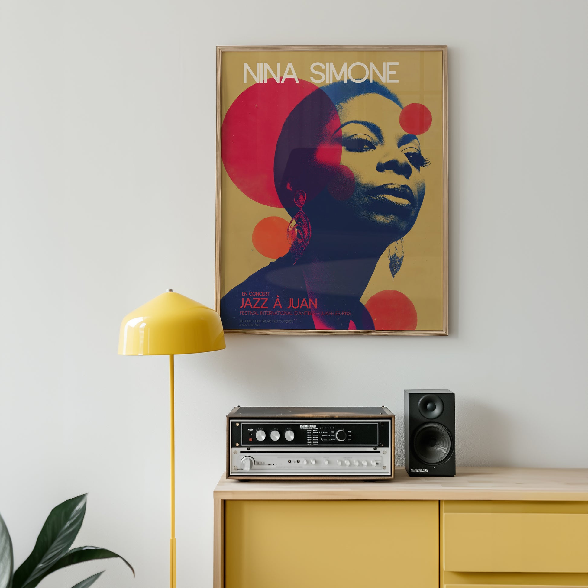 Framed Nina Simone poster on a wall above a yellow cabinet with stereo equipment.