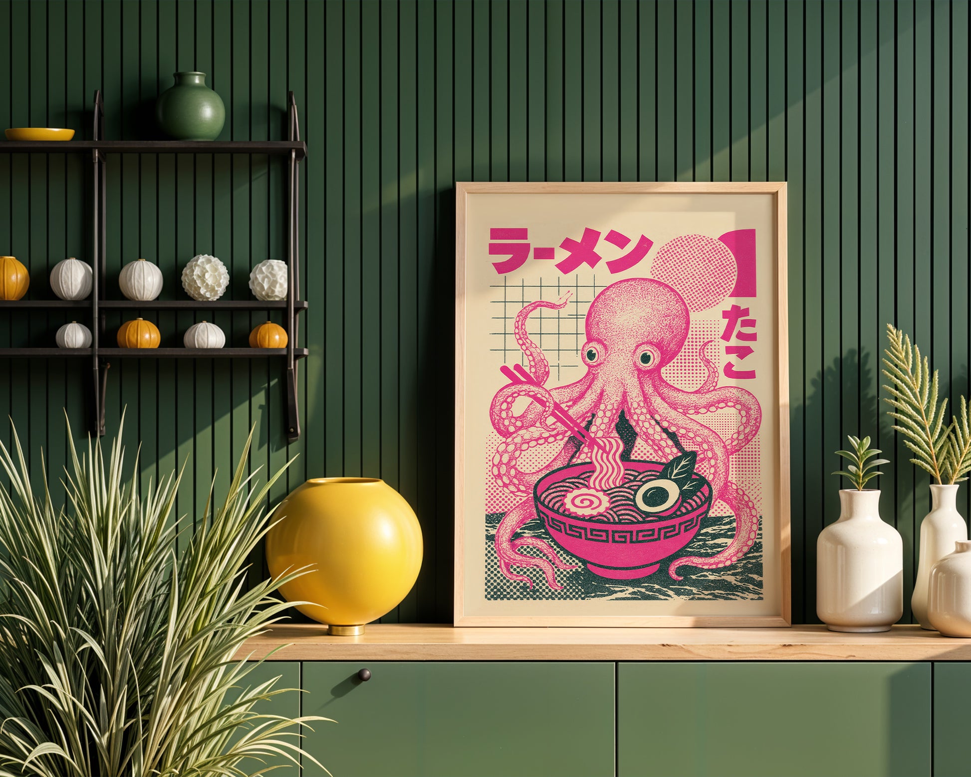 Framed artwork of a pink octopus with a bowl of ramen on a wooden shelf against a modern kitchen interior.