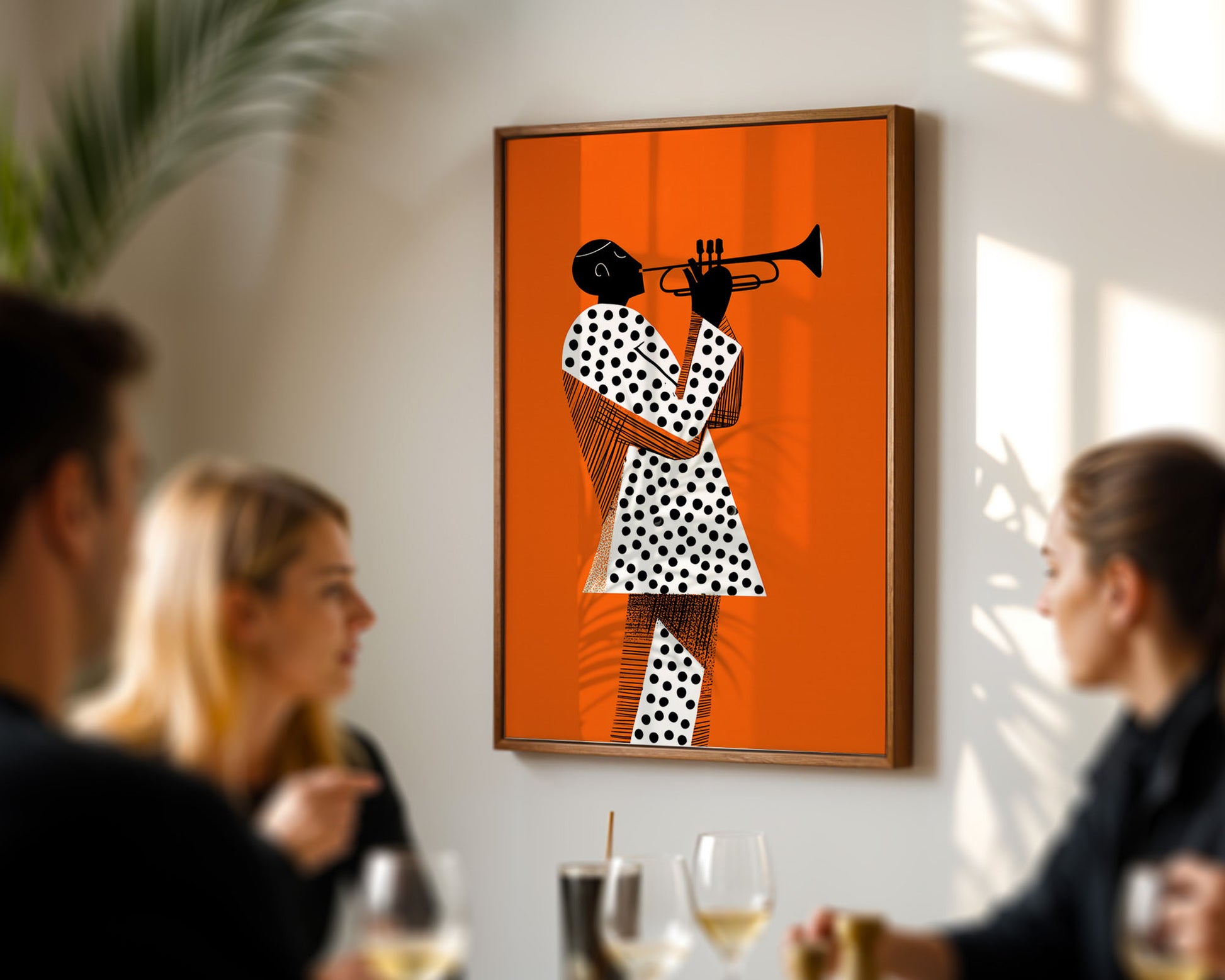 Mid-century inspired art poster of a person playing a trumpet on an orange background, hanging above a table with people socializing.