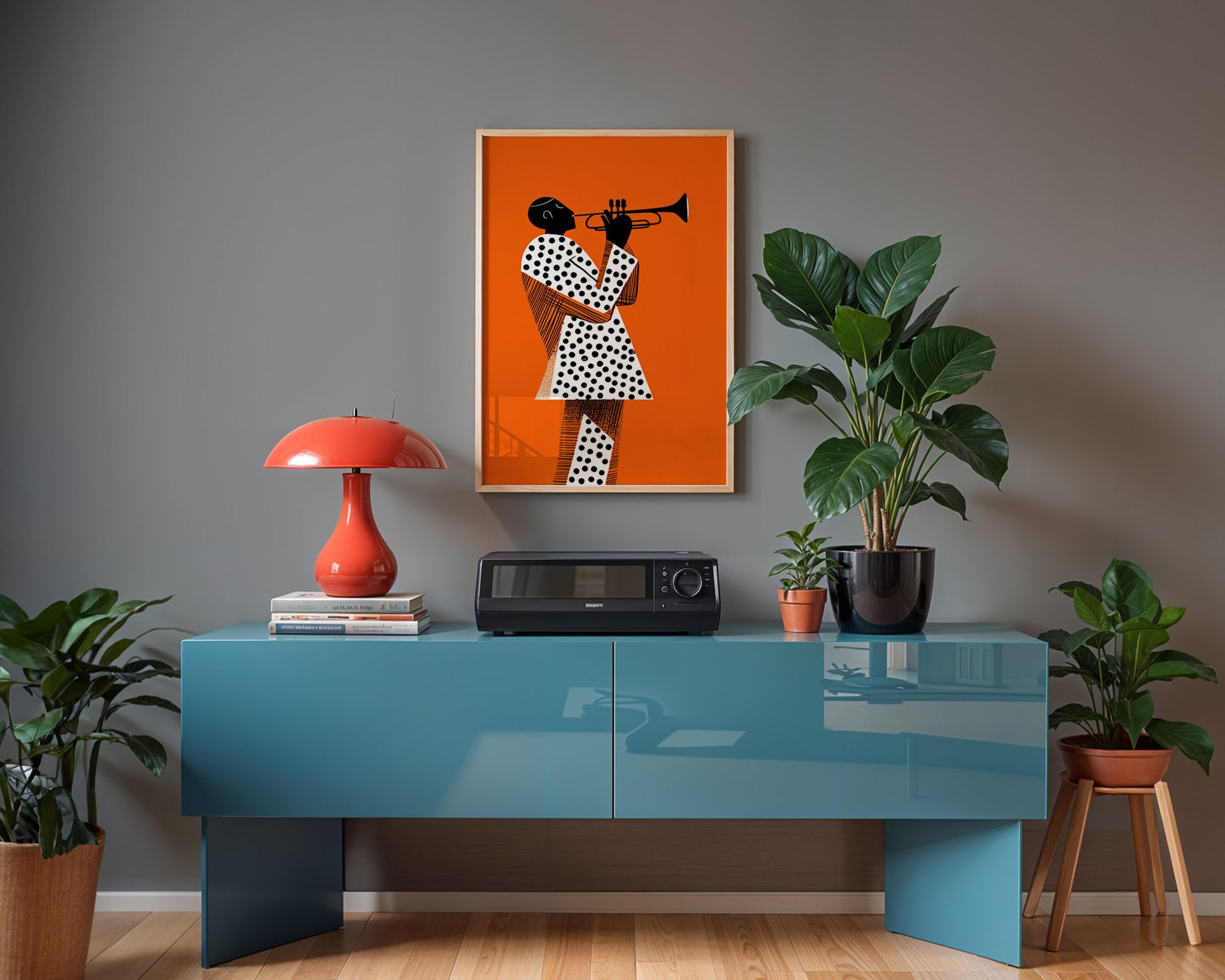 Modern interior with a blue console table, red lamp, and framed artwork on a gray wall.
