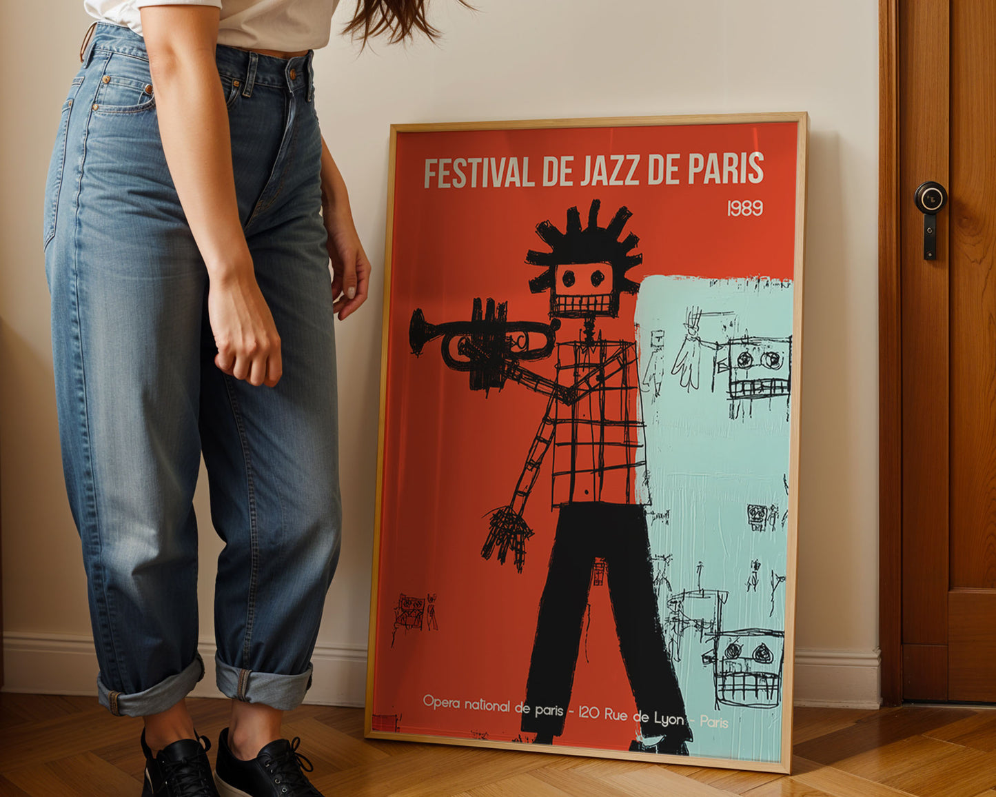 Person standing next to a framed poster of the Festival de Jazz de Paris 1989.