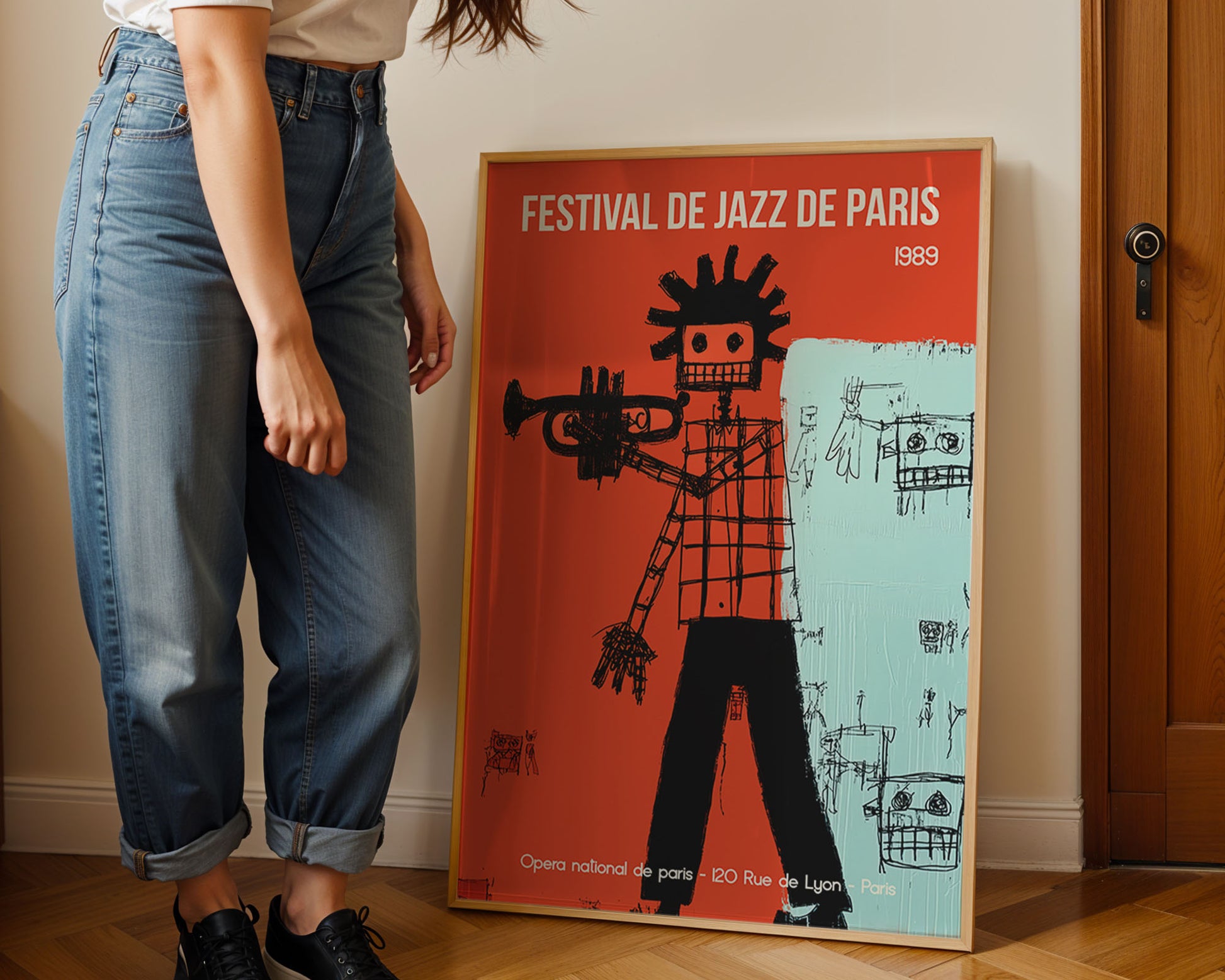 Person standing next to a framed poster of the Festival de Jazz de Paris 1989.