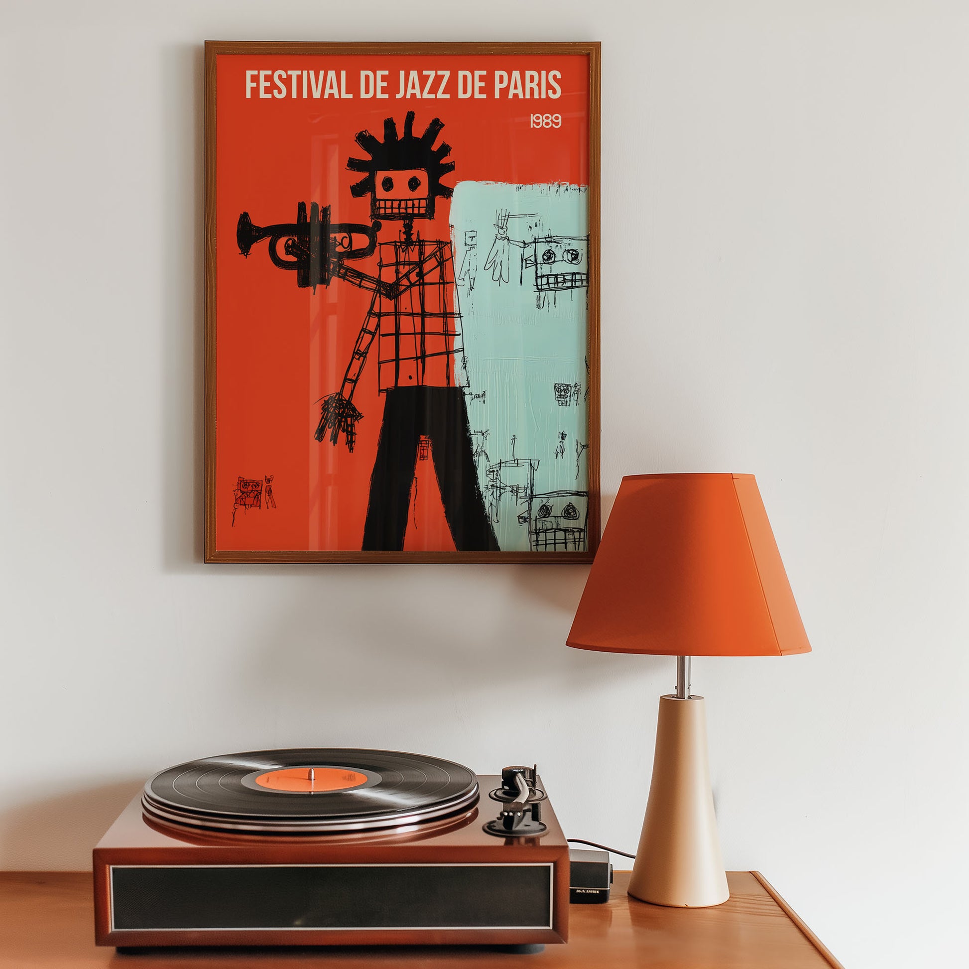 Framed poster of 'Festival de Jazz de Paris' above a record player with an orange lamp.