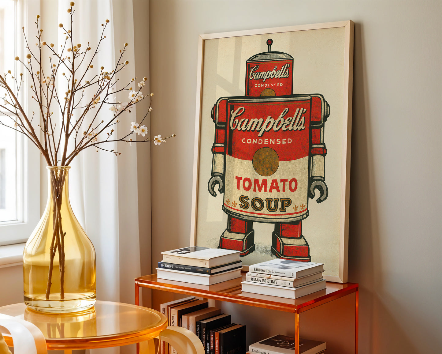 Campbell's Tomato Soup can artwork on a wall above a shelf with books and a vase.