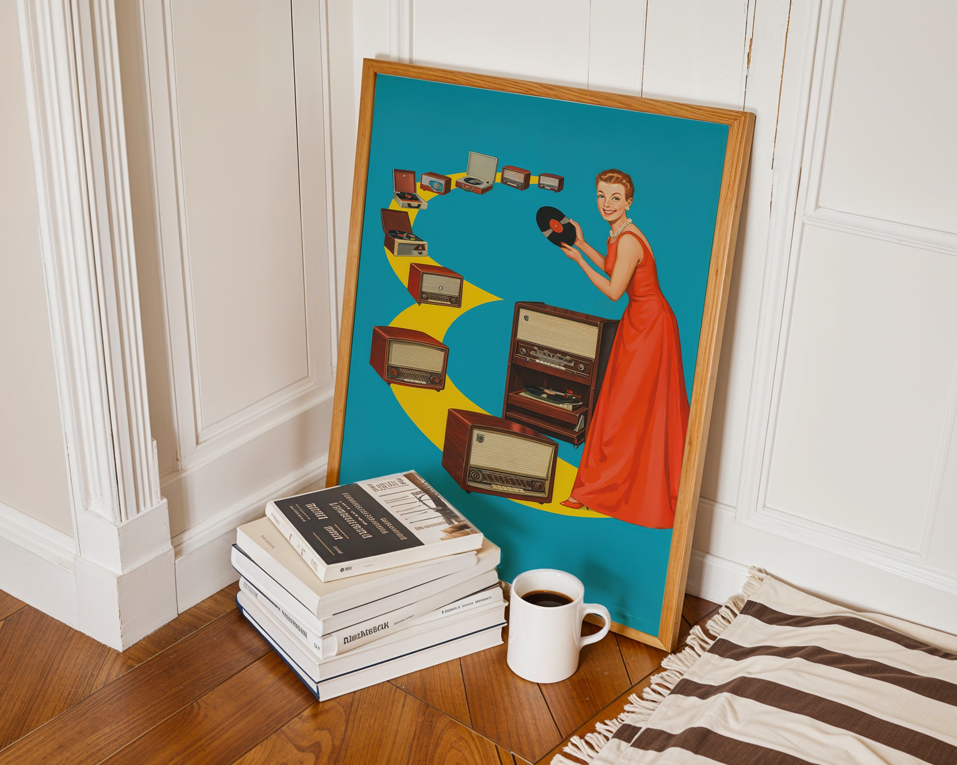 Framed artwork of a woman holding a camera, leaning against a wall with books and a coffee cup on the floor.
