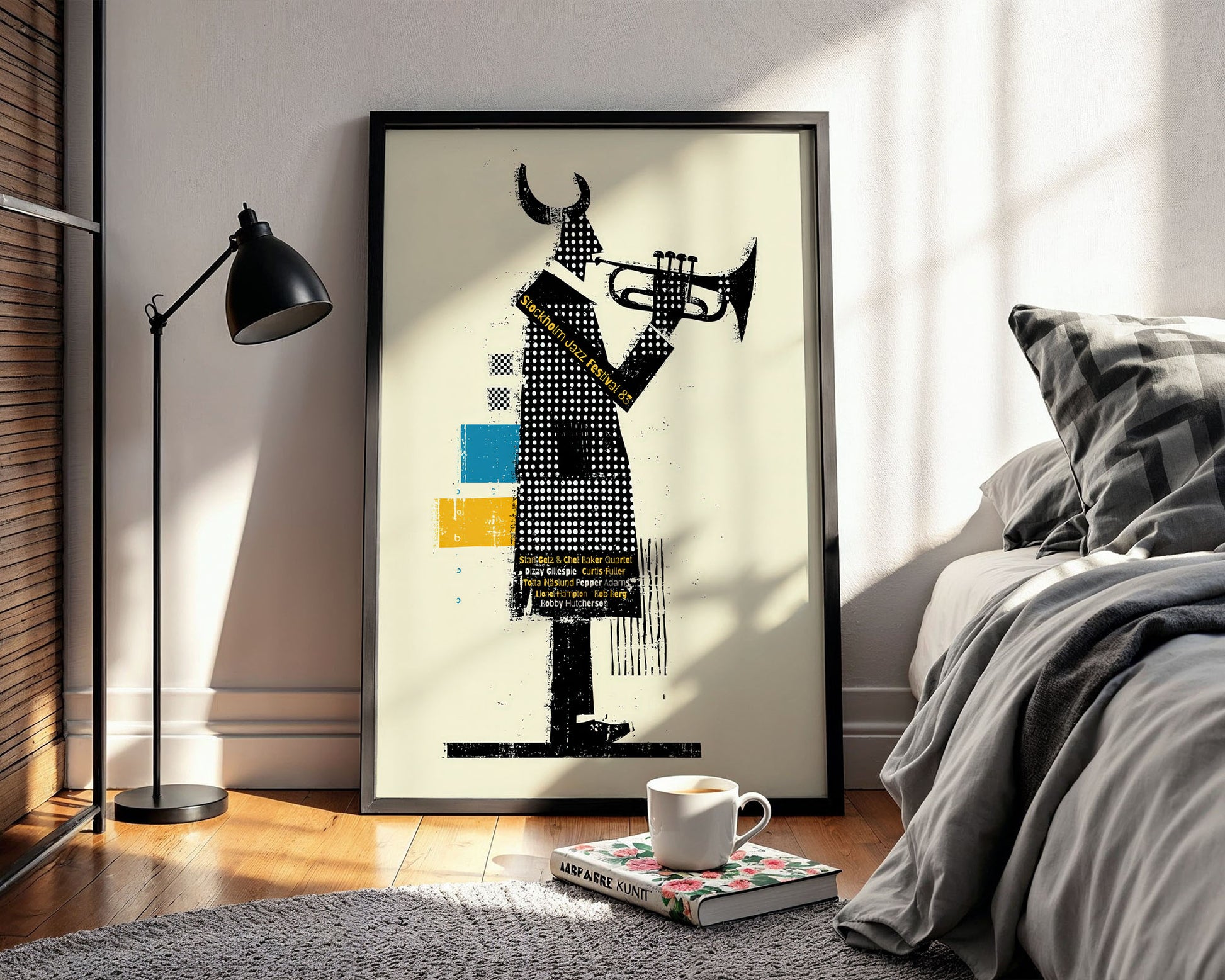 Framed abstract art piece in a modern bedroom setting with a lamp and bed.