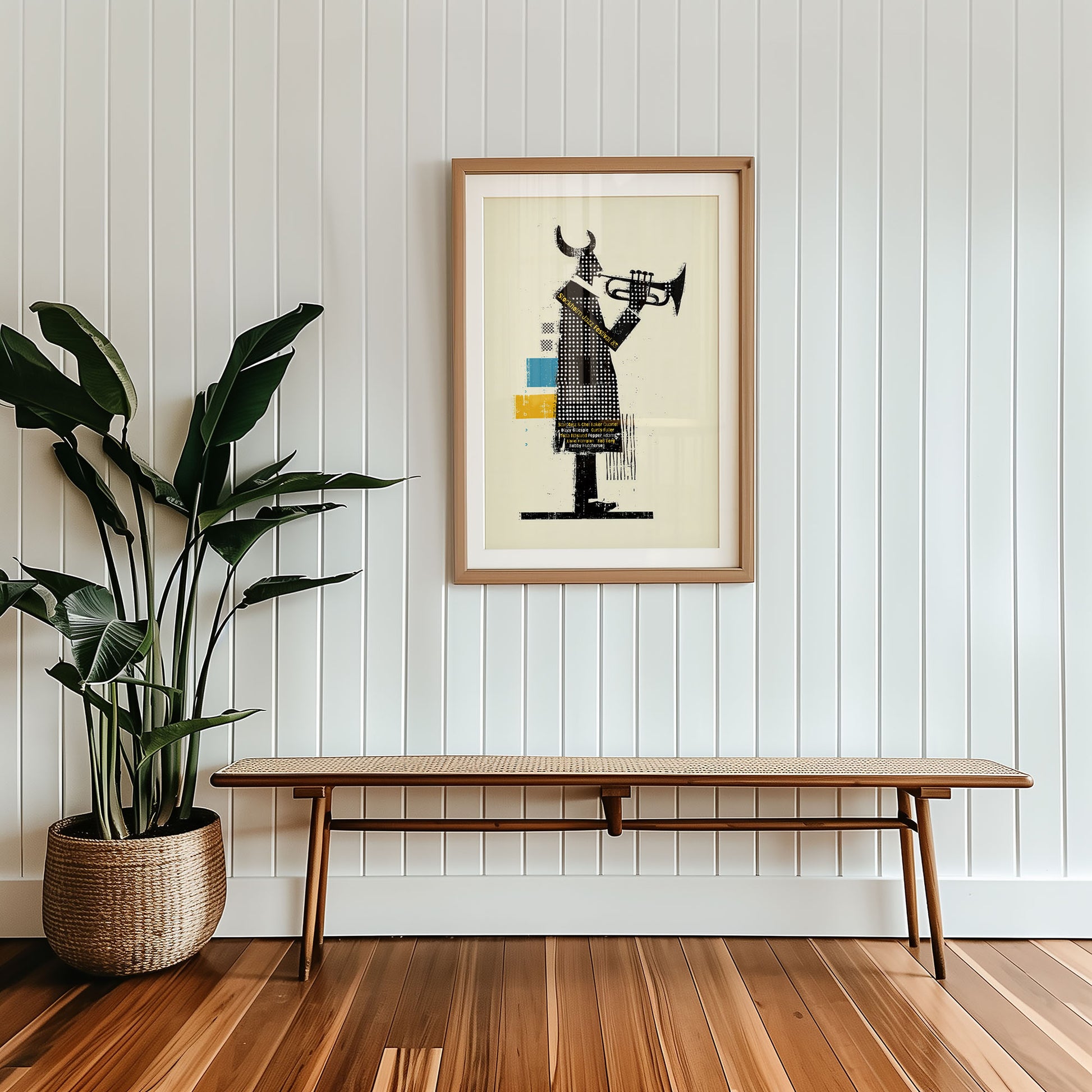 Framed artwork on a wall with a wooden bench and plant below.